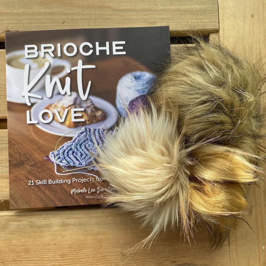 brioche knit love book and faux fur pom poms